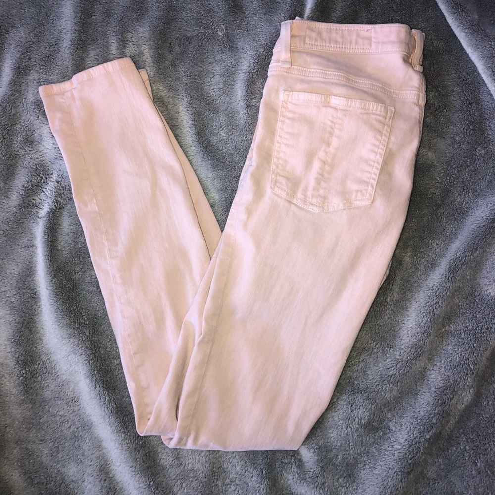 Distressed light pink jeans